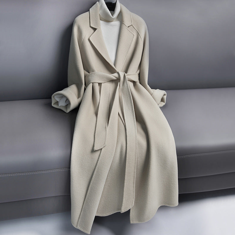 Woman wearing long wool winter coat with belt