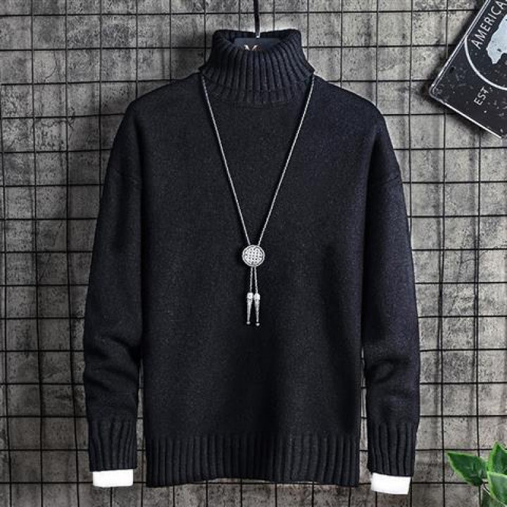 Man wearing black slim fit turtleneck sweater indoors