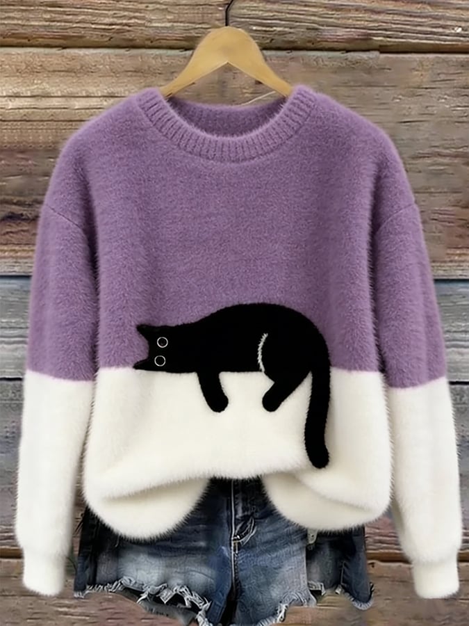 Woman wearing cat print knit sweater, relaxed fit