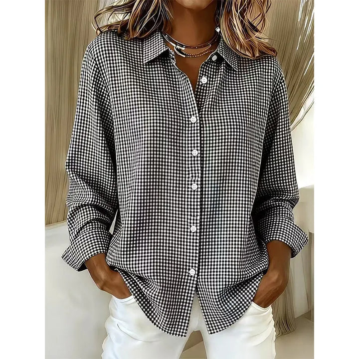 Woman wearing gingham check button-up blouse with long sleeves
