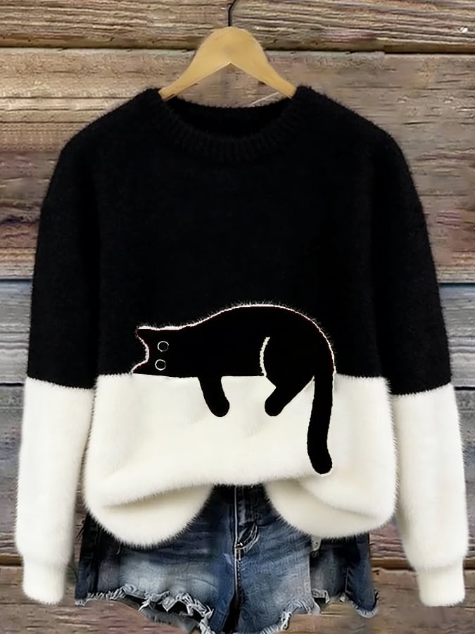 Woman wearing cat print knit sweater, relaxed fit