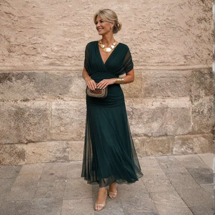 Woman wearing V-neck maxi dress with flowy skirt
