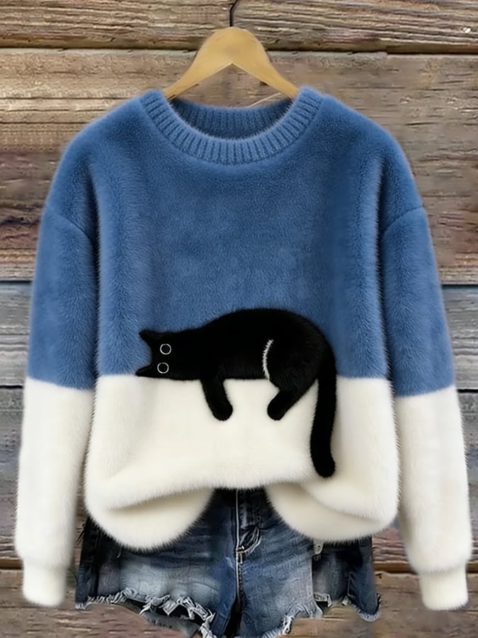 Woman wearing cat print knit sweater, relaxed fit