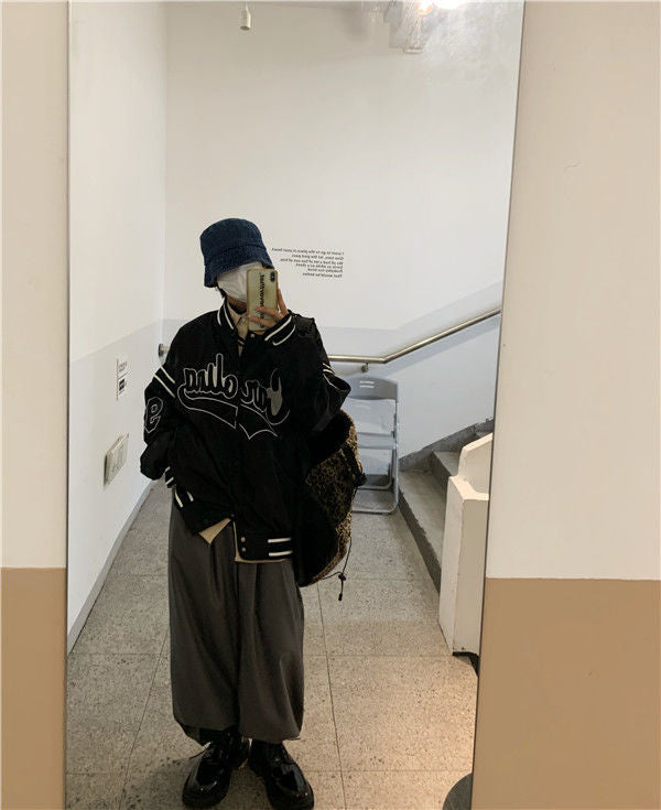 Woman wearing loose hip hop jacket with letter print