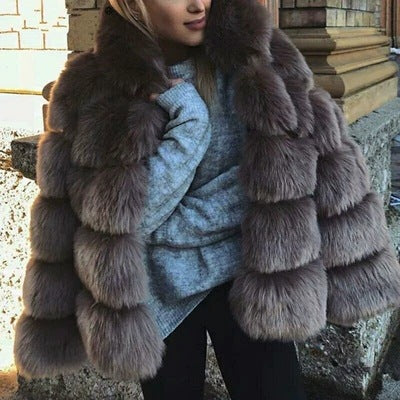 Woman wearing short faux fur coat with long sleeves