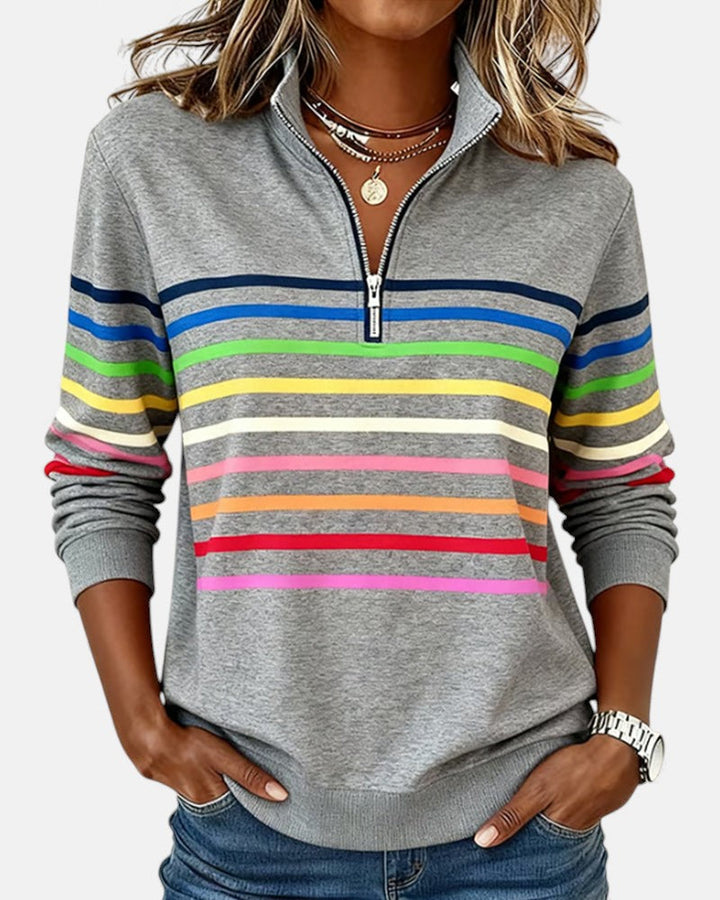 Woman wearing rainbow striped half zip sweatshirt