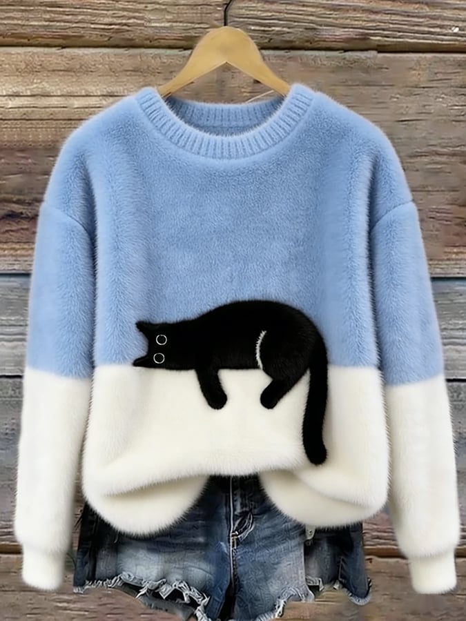 Woman wearing cat print knit sweater, relaxed fit