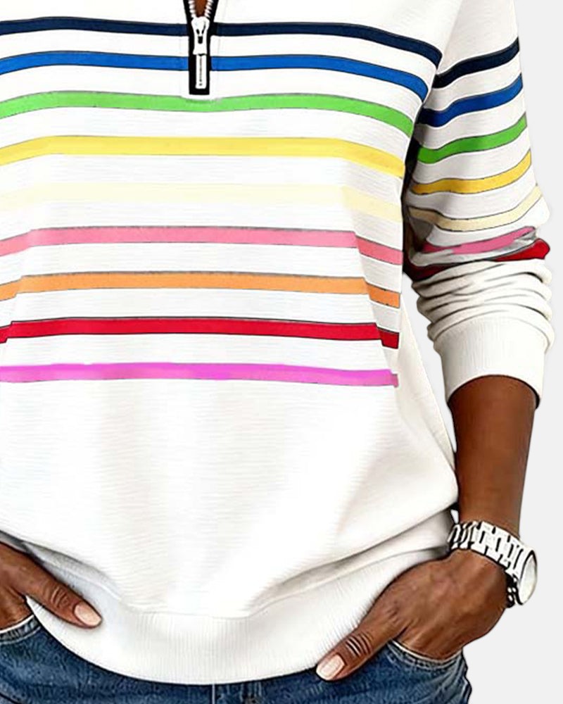 Woman wearing rainbow striped half zip sweatshirt