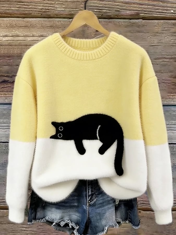 Woman wearing cat print knit sweater, relaxed fit