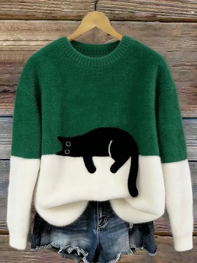Woman wearing cat print knit sweater, relaxed fit