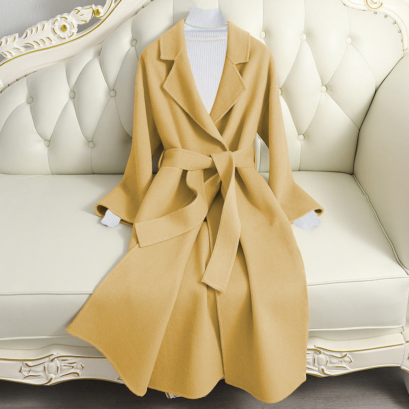Woman wearing long wool winter coat with belt