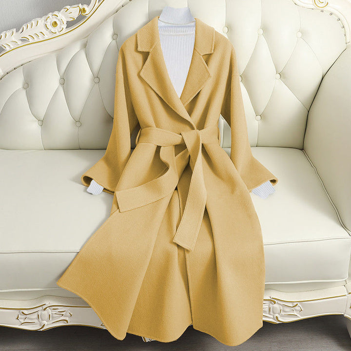 Woman wearing long wool winter coat with belt