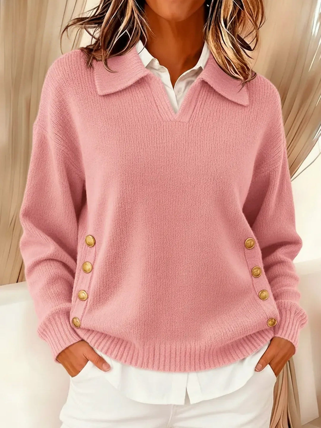 Woman wearing V-neck sweater with collar and gold buttons