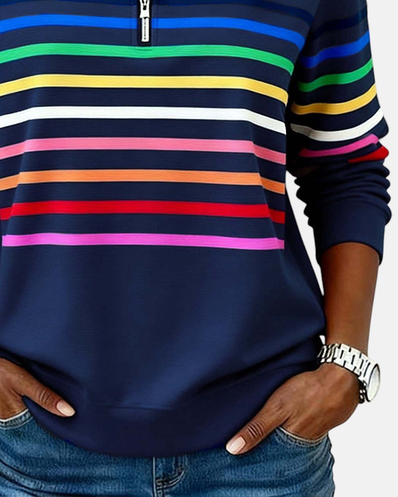Woman wearing rainbow striped half zip sweatshirt