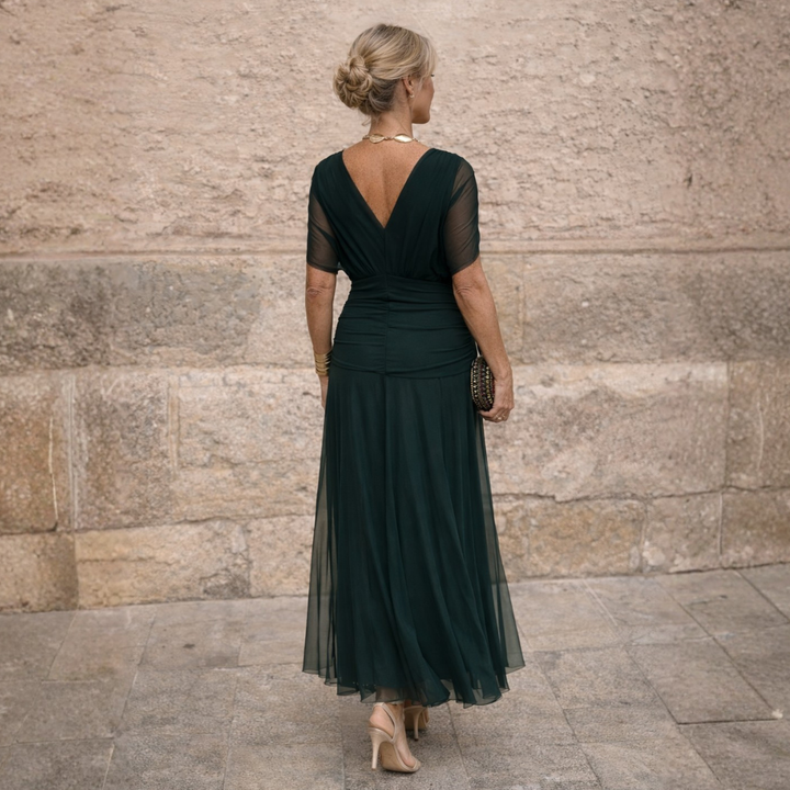 Woman wearing V-neck maxi dress with flowy skirt