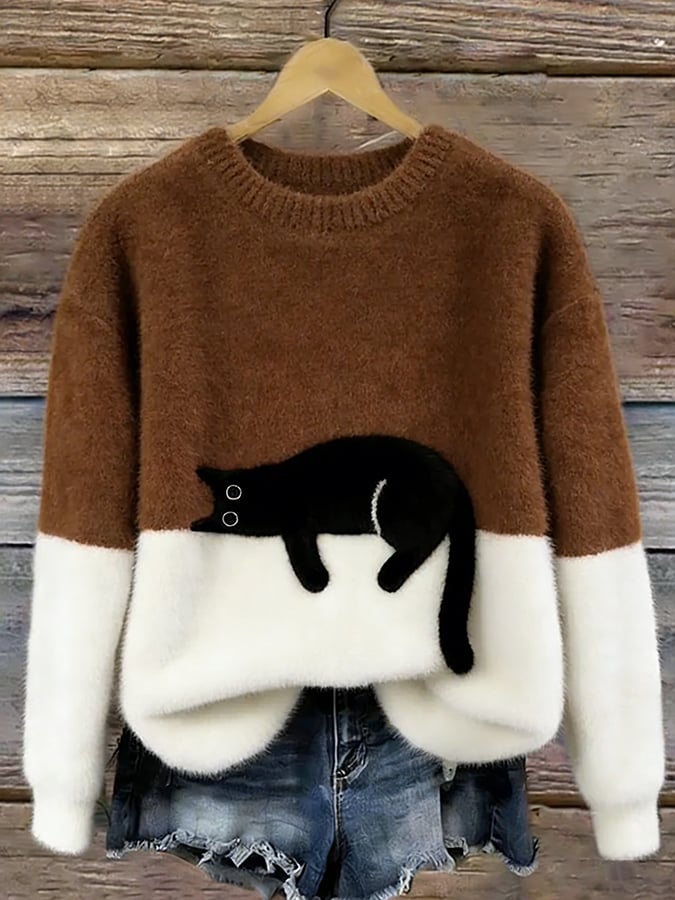 Woman wearing cat print knit sweater, relaxed fit