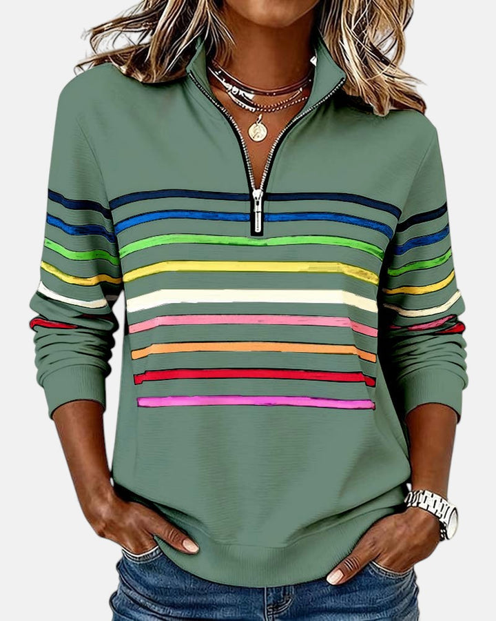 Woman wearing rainbow striped half zip sweatshirt
