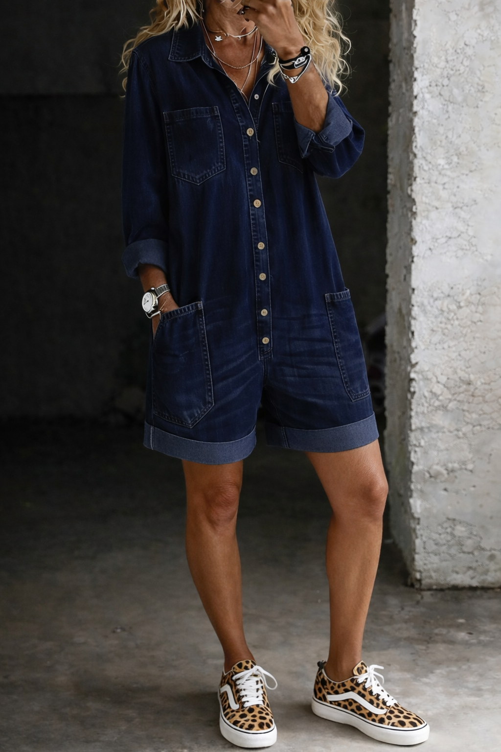 Woman wearing short denim-look jumpsuit with relaxed fit