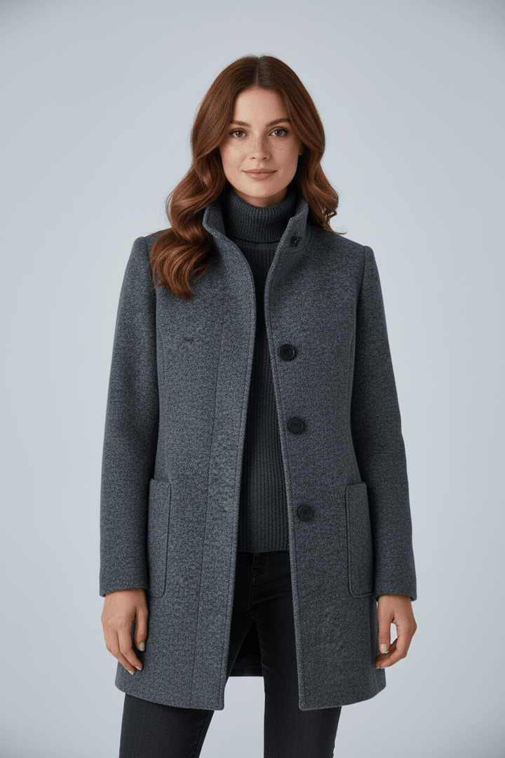 Woman wearing tailored overcoat with stand collar