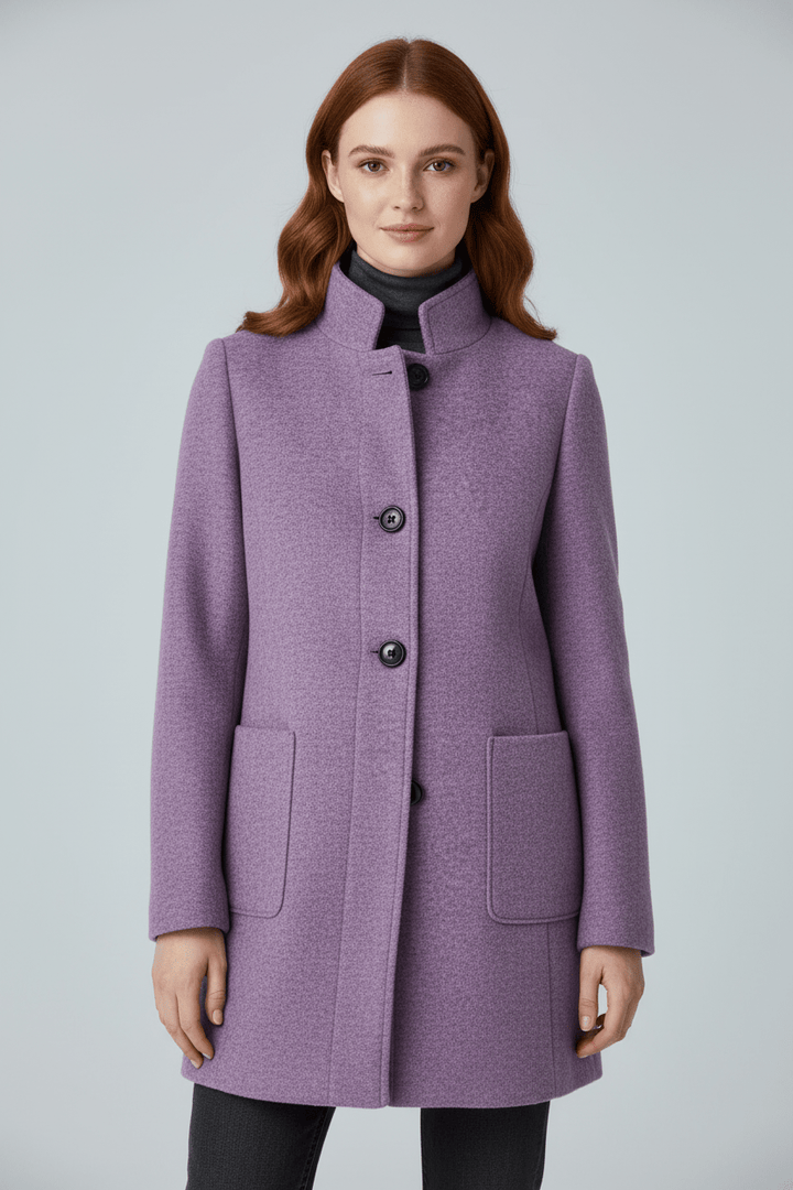 Woman wearing tailored overcoat with stand collar