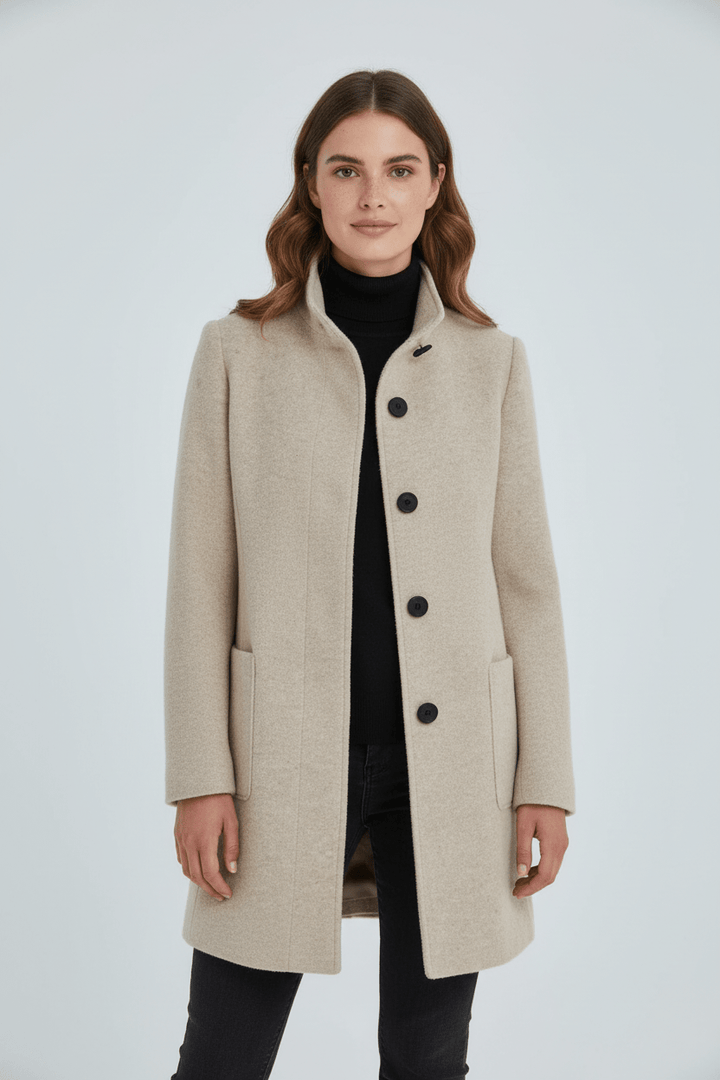 Woman wearing tailored overcoat with stand collar