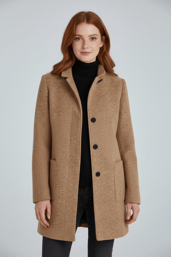 Woman wearing tailored overcoat with stand collar