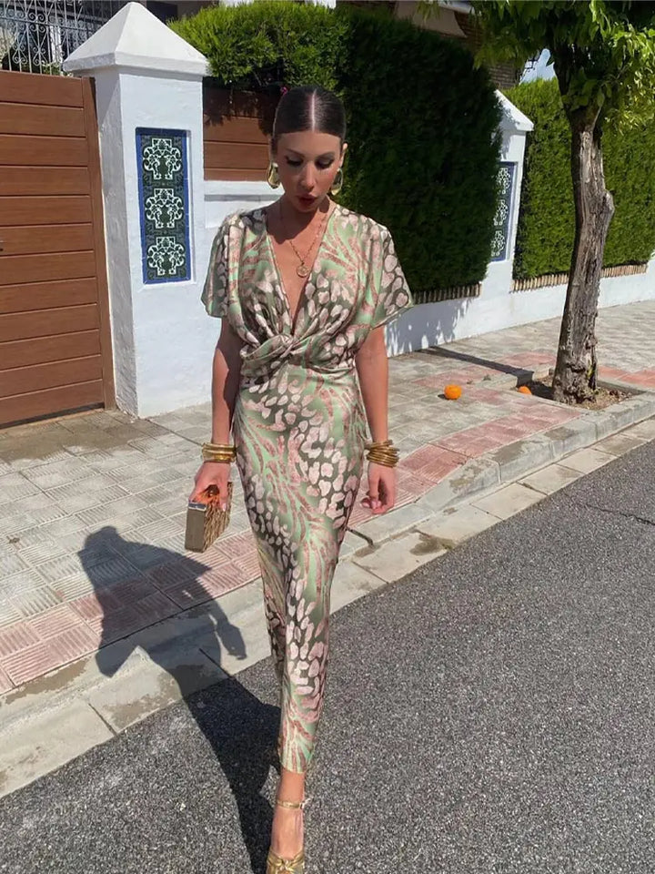 Woman wearing maxi dress with deep V-neck and wrap detail