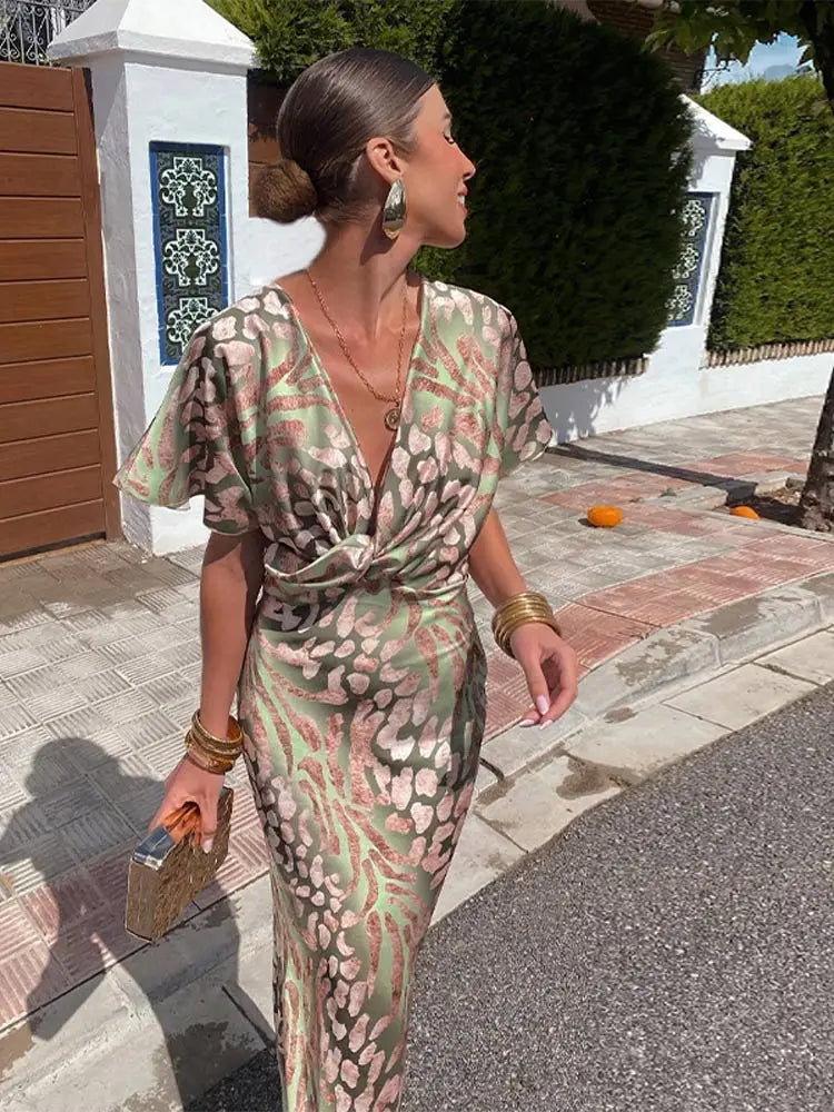 Woman wearing maxi dress with deep V-neck and wrap detail