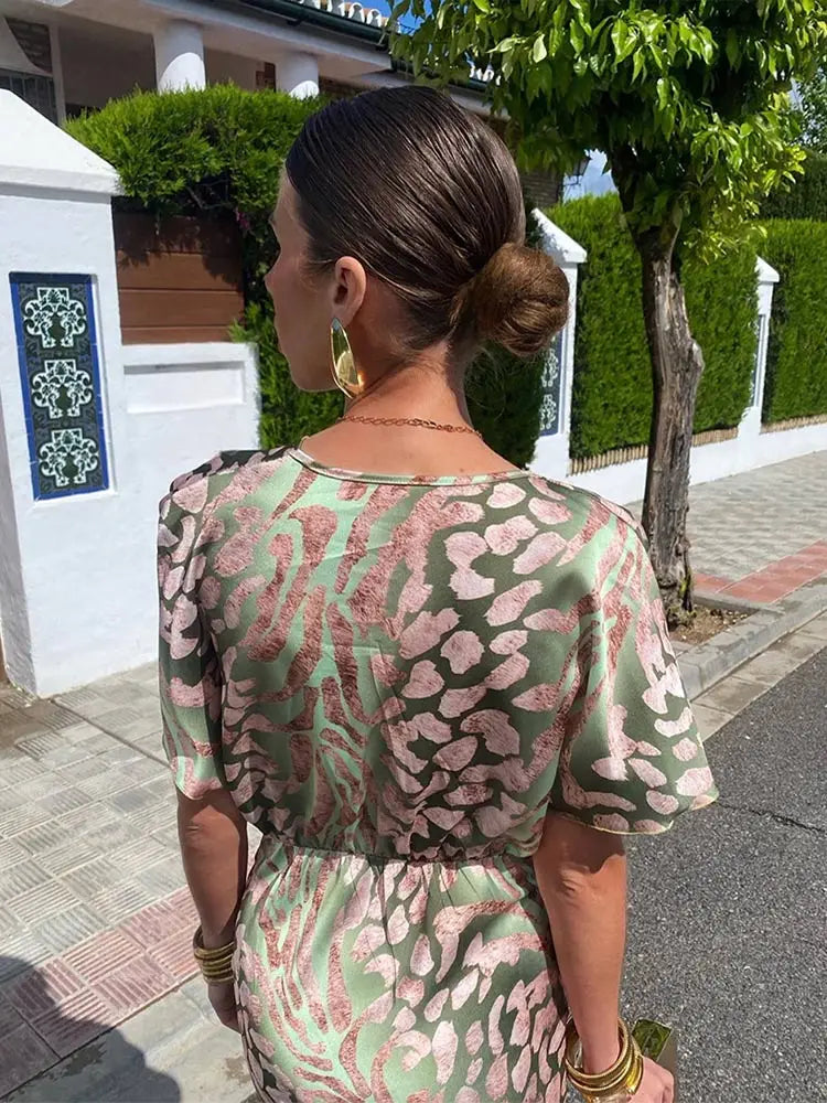 Woman wearing maxi dress with deep V-neck and wrap detail