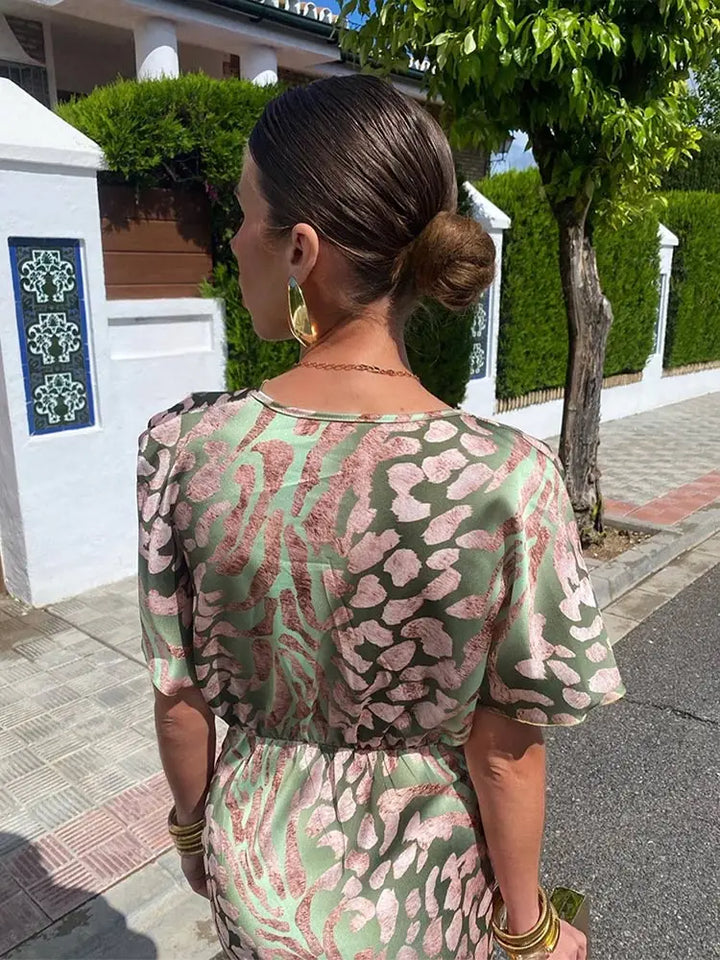 Woman wearing maxi dress with deep V-neck and wrap detail