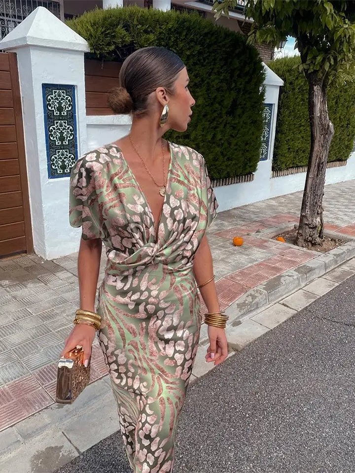 Woman wearing maxi dress with deep V-neck and wrap detail