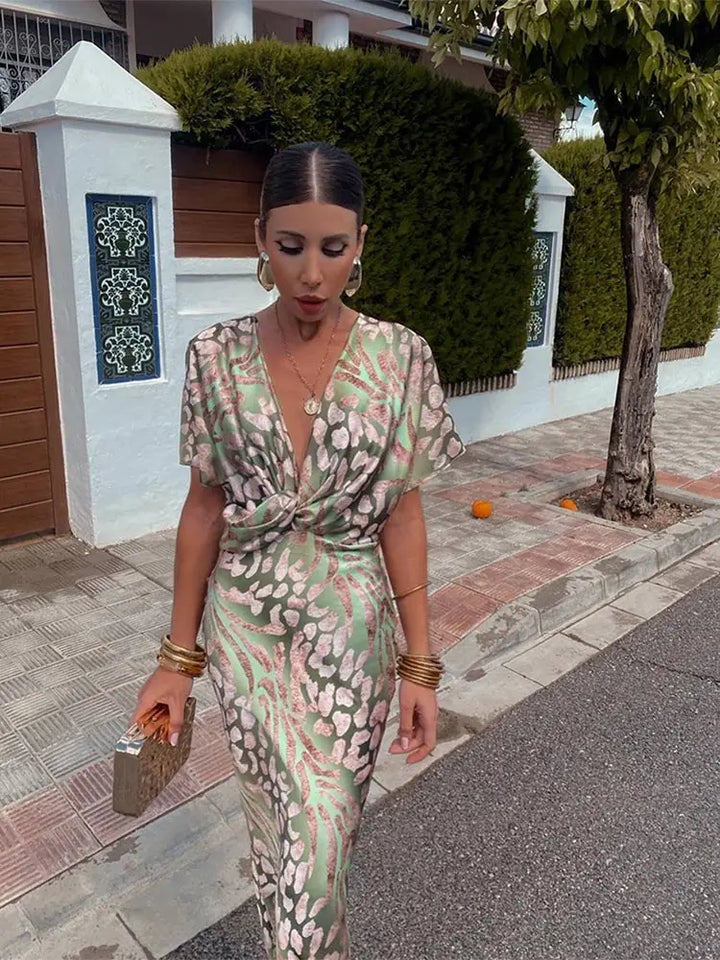 Woman wearing maxi dress with deep V-neck and wrap detail