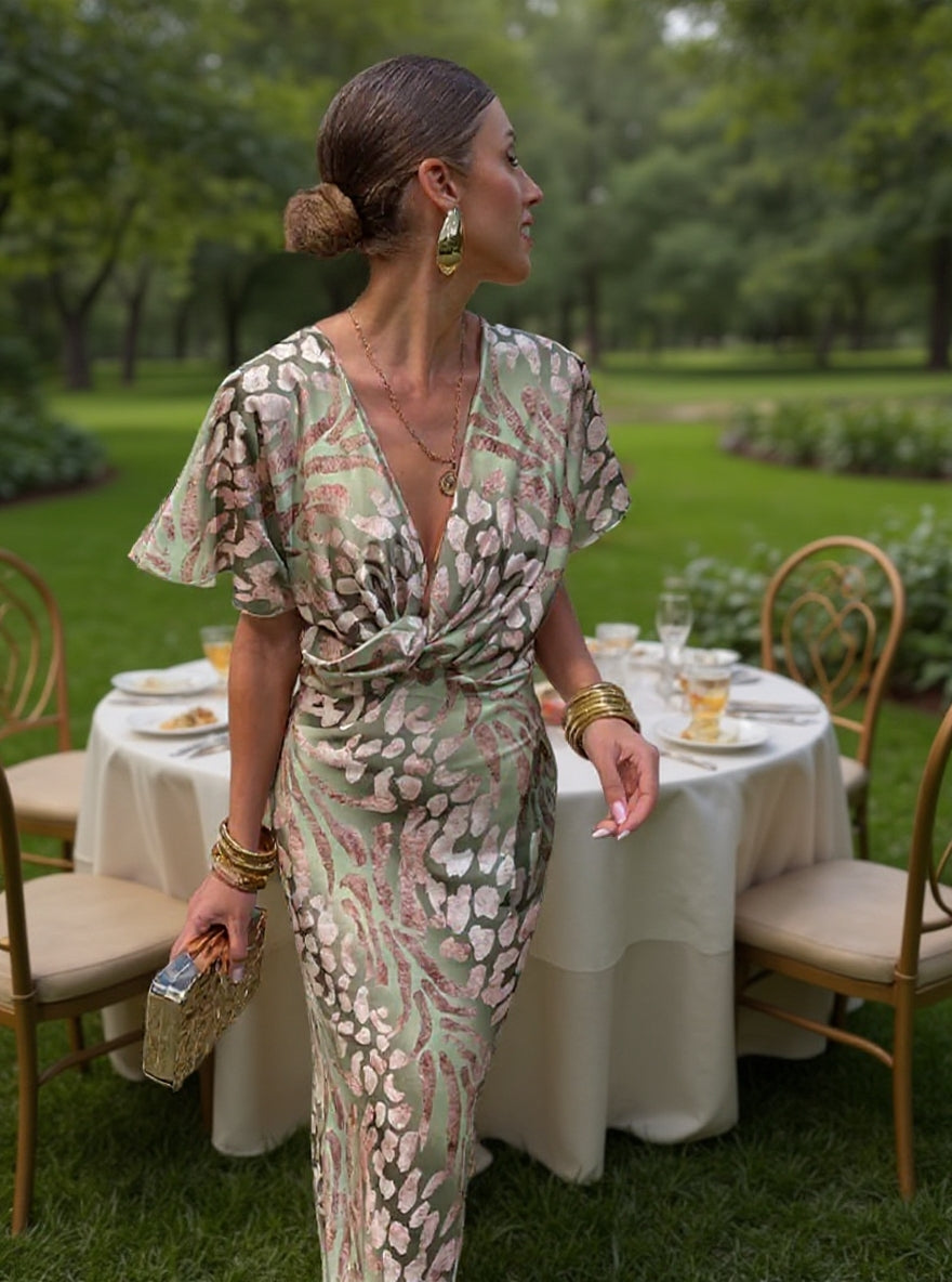 Woman wearing maxi dress with deep V-neck and wrap detail