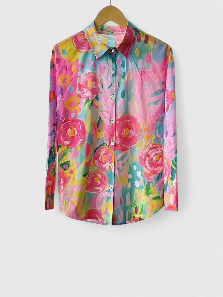 Woman wearing printed button-up blouse with artistic print