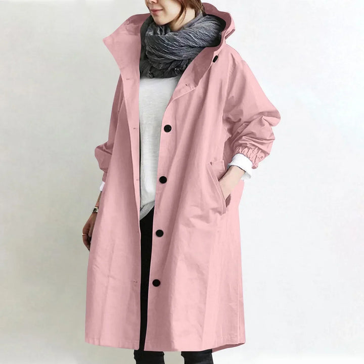 Woman wearing long hooded coat with button front