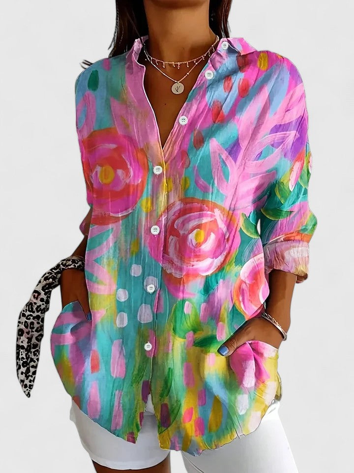 Woman wearing printed button-up blouse with artistic print