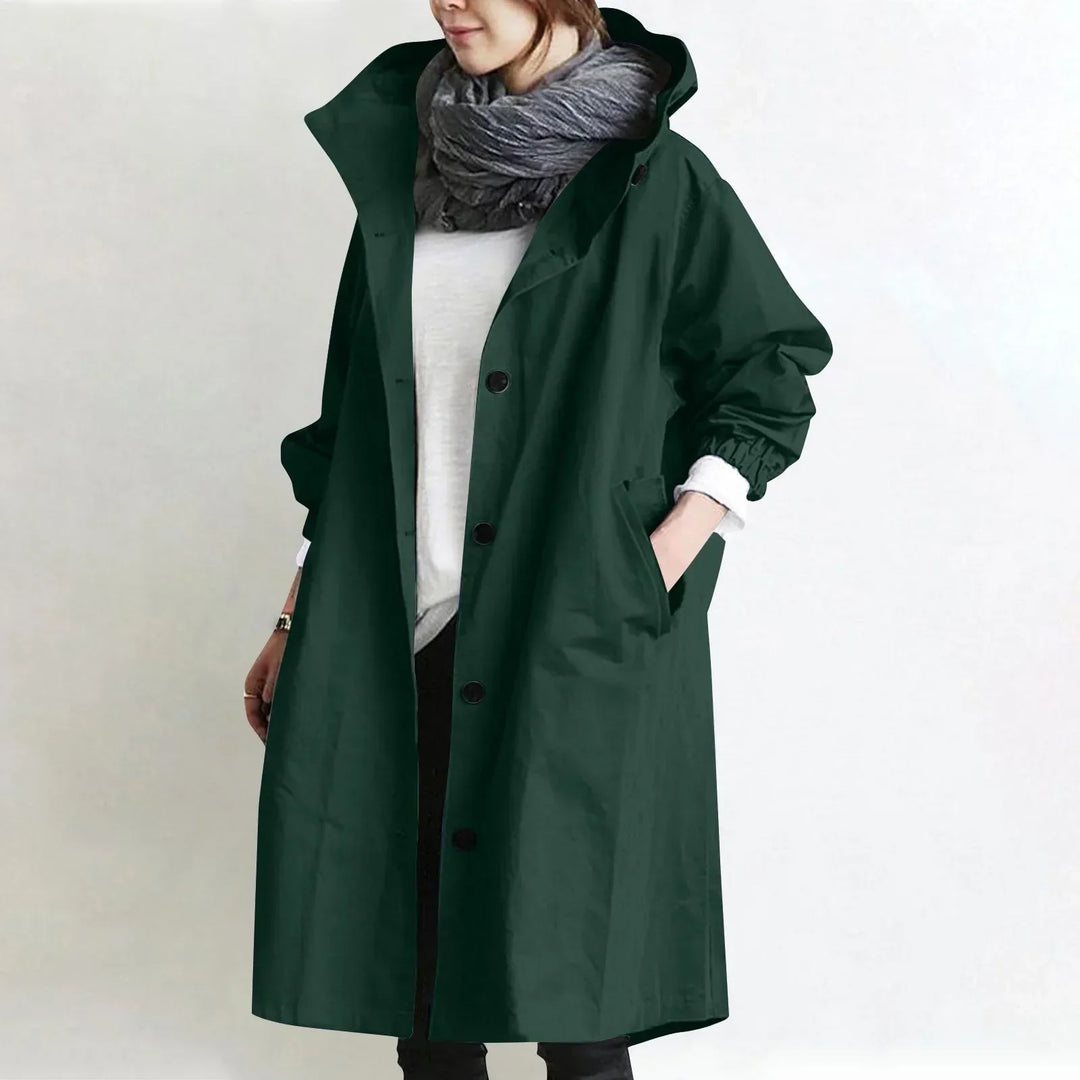 Woman wearing long hooded coat with button front