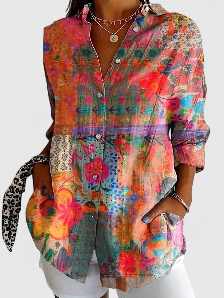 Woman wearing printed button-up blouse with artistic print