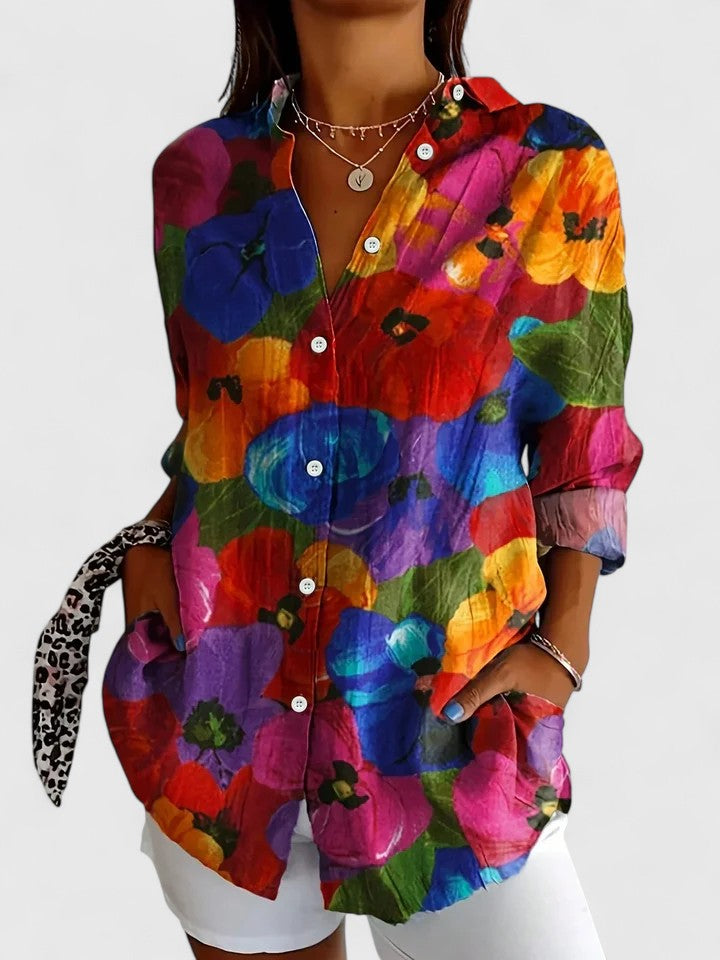 Woman wearing printed button-up blouse with artistic print