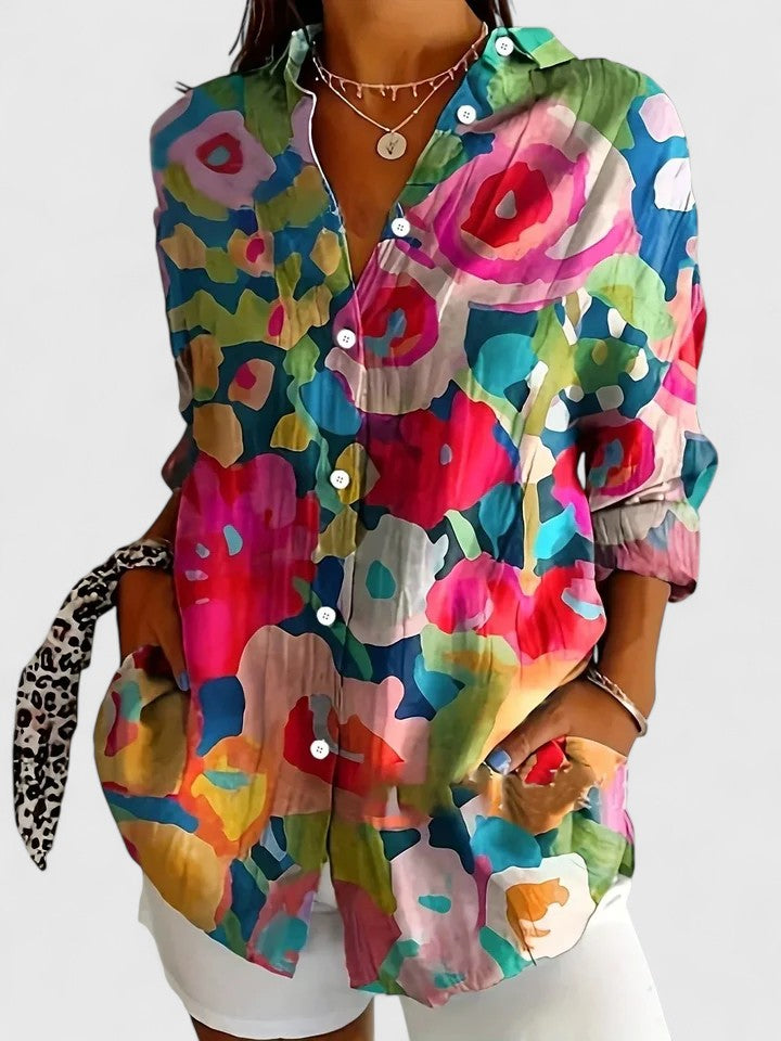 Woman wearing printed button-up blouse with artistic print
