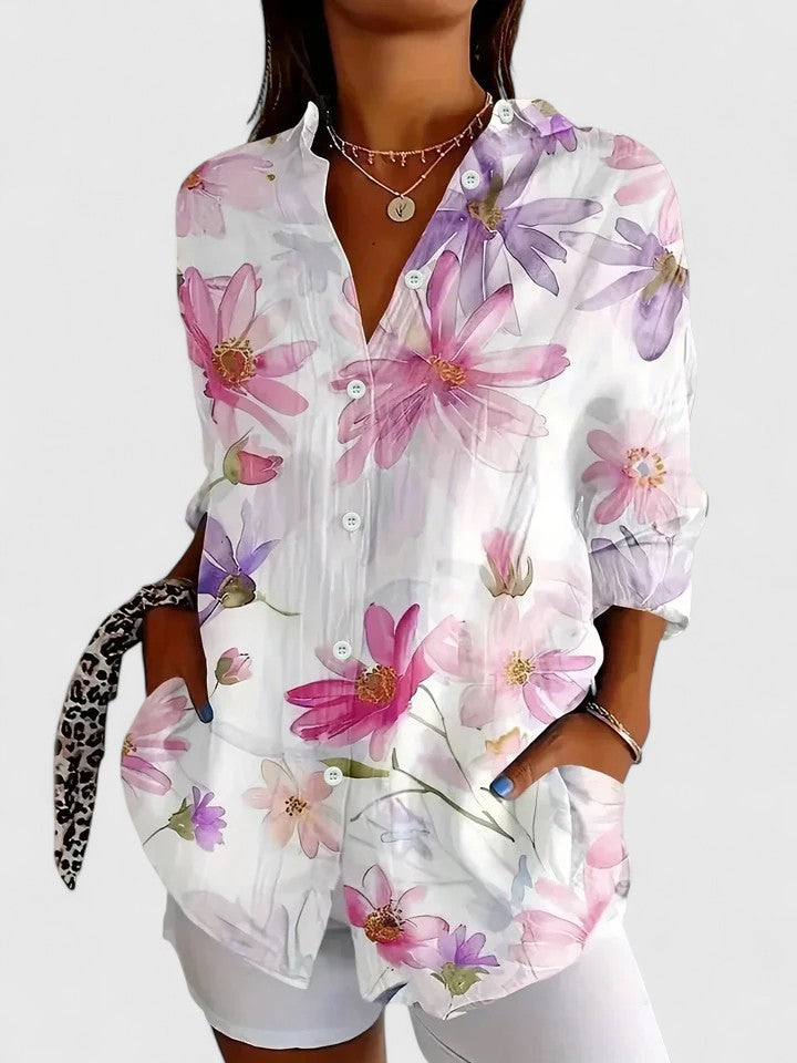Woman wearing printed button-up blouse with artistic print