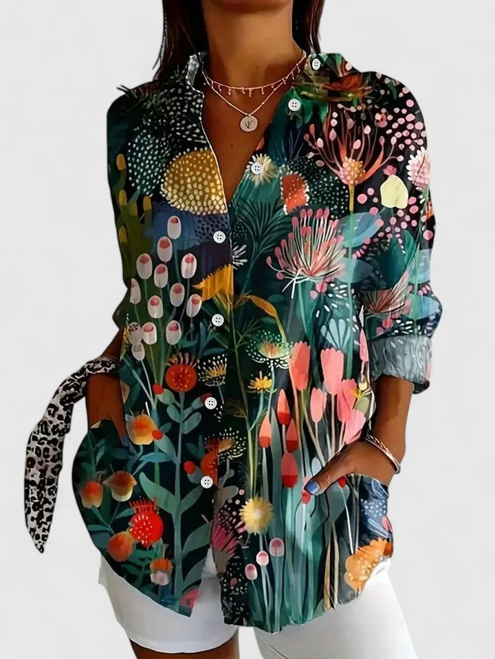 Woman wearing printed button-up blouse with artistic print