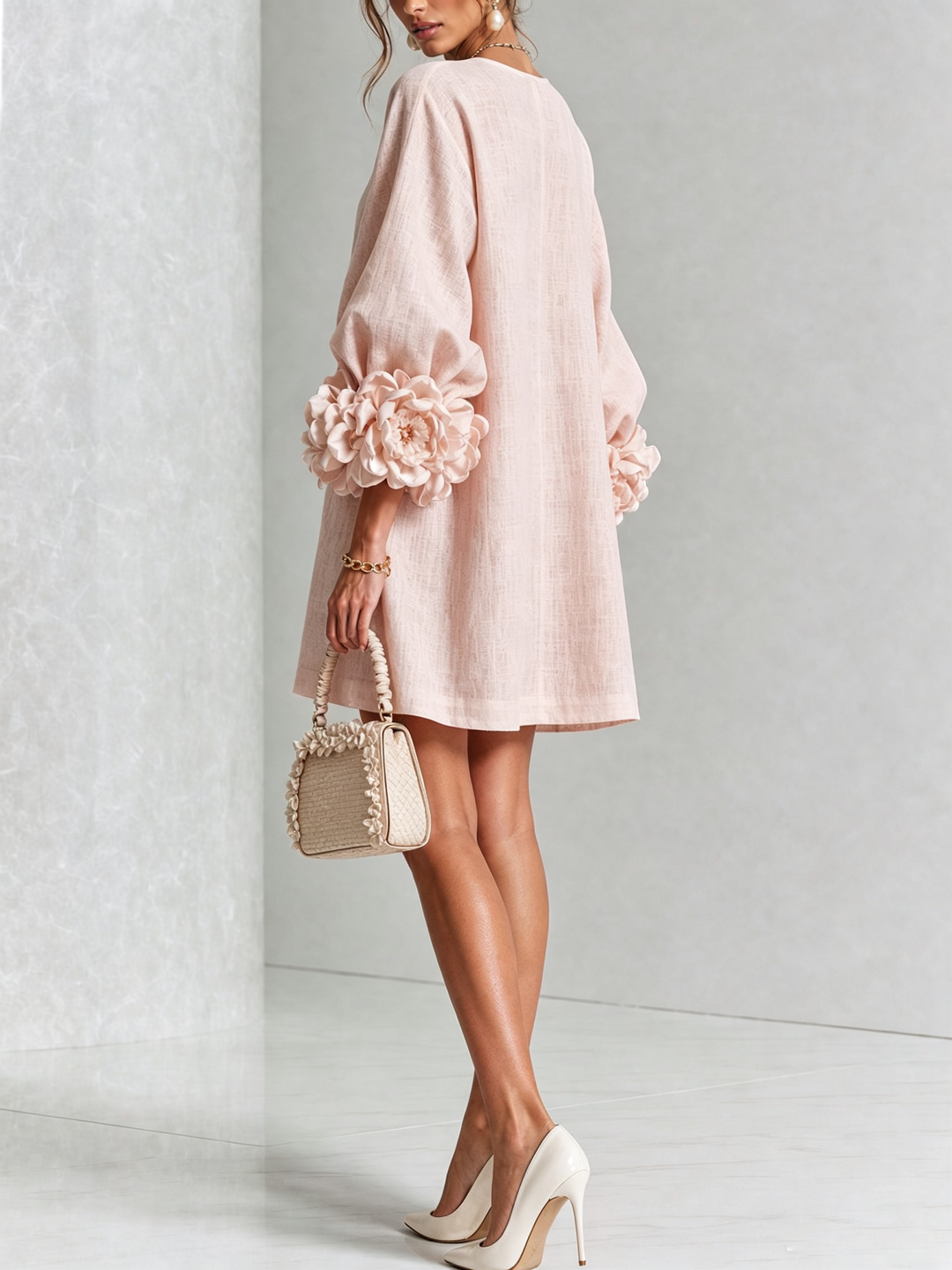 Pink mini dress with button front and rosette cuffs