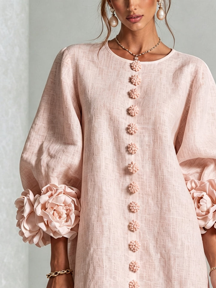 Pink mini dress with button front and rosette cuffs