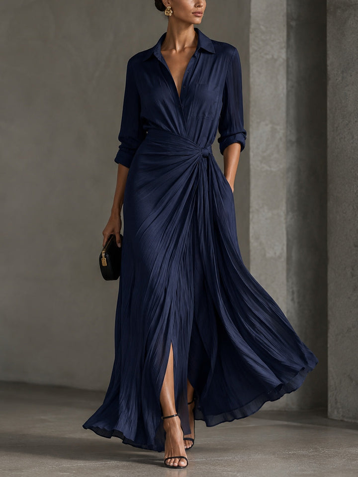 Woman wearing navy V-neck knotted maxi dress with side slit