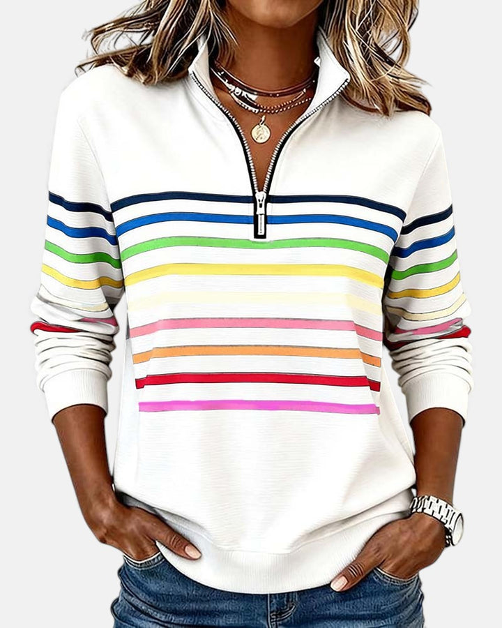 Woman wearing rainbow striped half zip sweatshirt