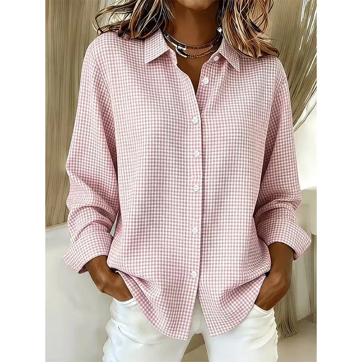 Woman wearing gingham check button-up blouse with long sleeves