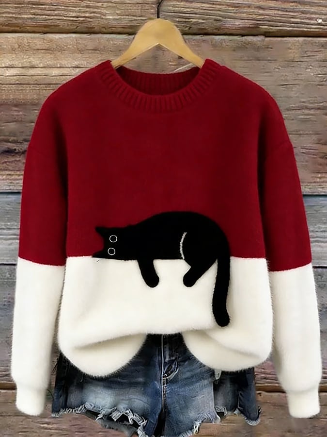Woman wearing cat print knit sweater, relaxed fit