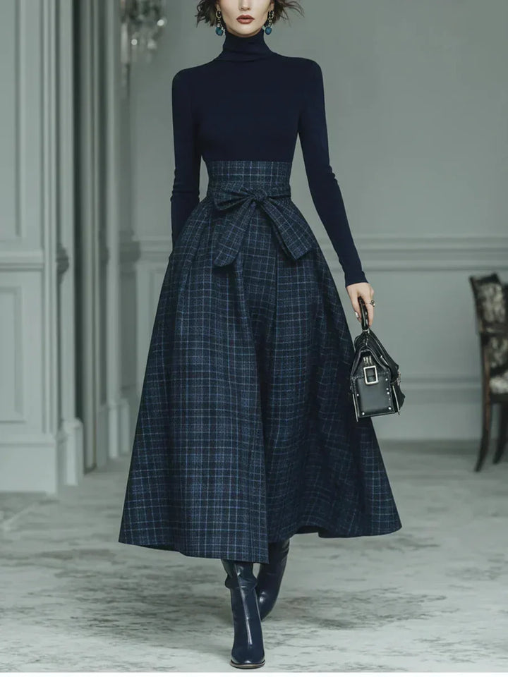 Woman wearing dark blue high-neck top and plaid skirt set