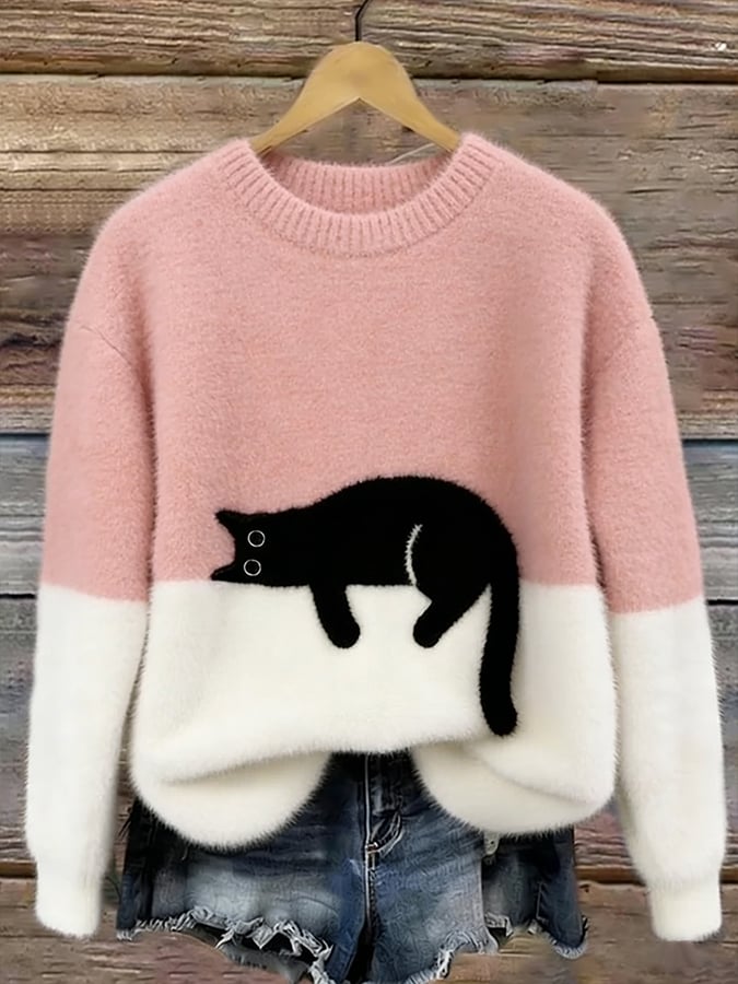 Woman wearing cat print knit sweater, relaxed fit